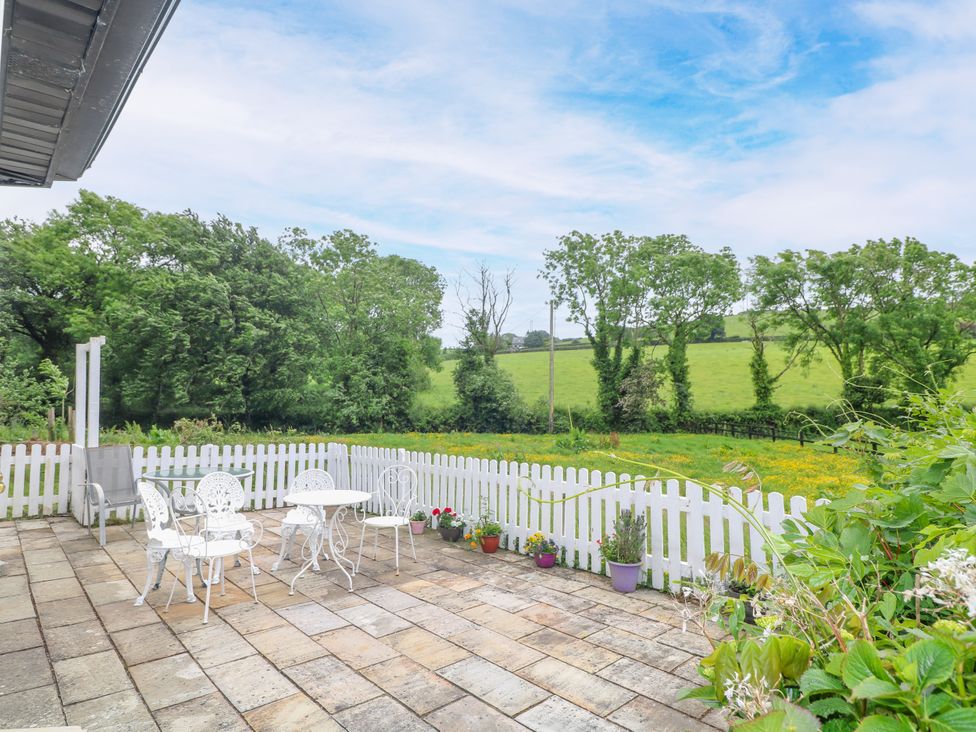 An outdoor patio with a table and chairs at The Lodge in Gorey, County Wexford