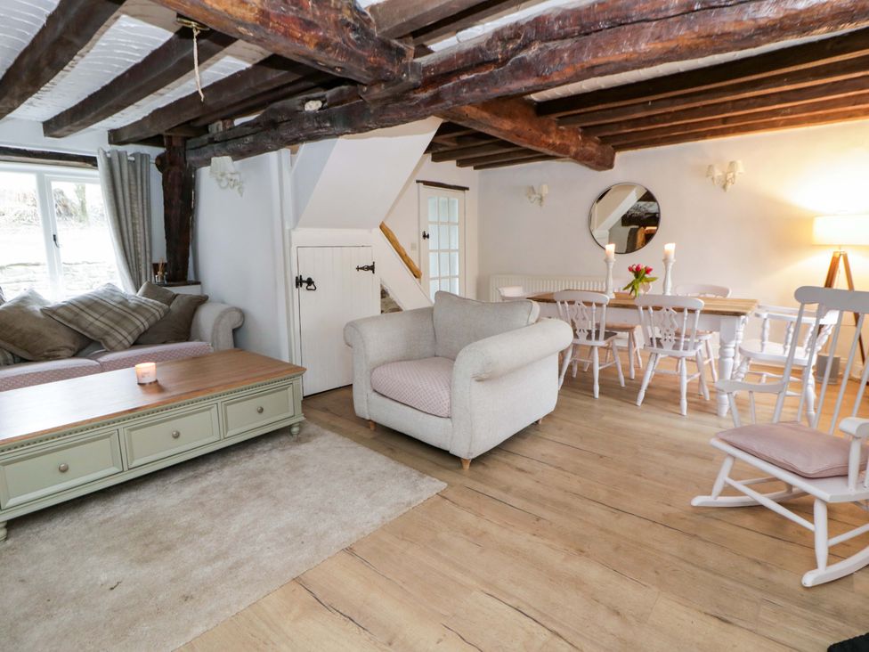 A living room with a sofa and dining table at The Old Shop in Builth Wells