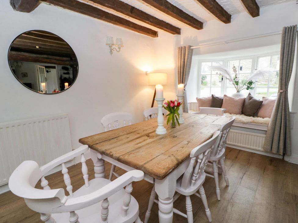 A dining room with a wooden table and chairs at The Old Shop in Builth Wells
