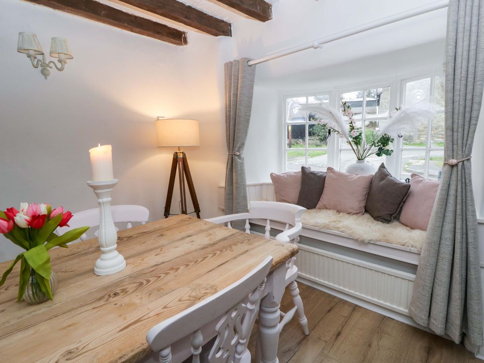 A dining room with a wooden table and chairs at The Old Shop in Builth Wells