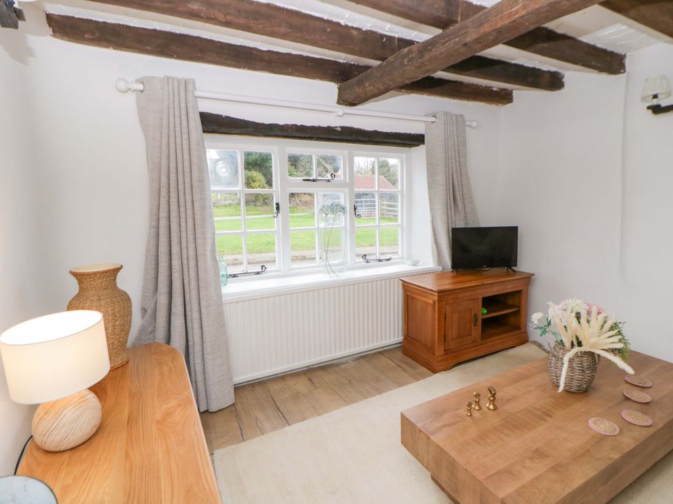 A living room with a window, tv and coffee table at The Old Shop in Builth Wells
