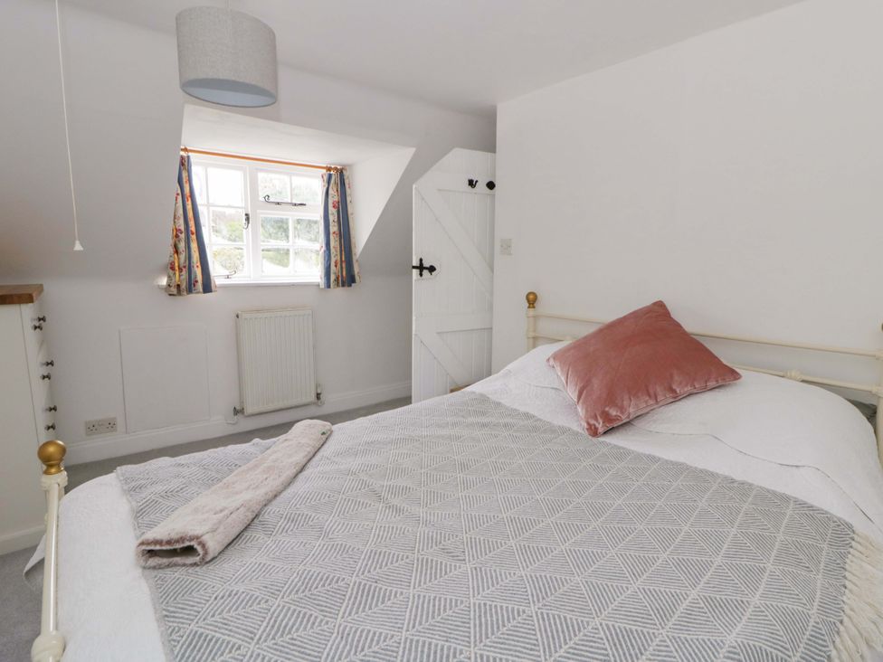 A bedroom with a bed and window at The Old Shop in Builth Wells