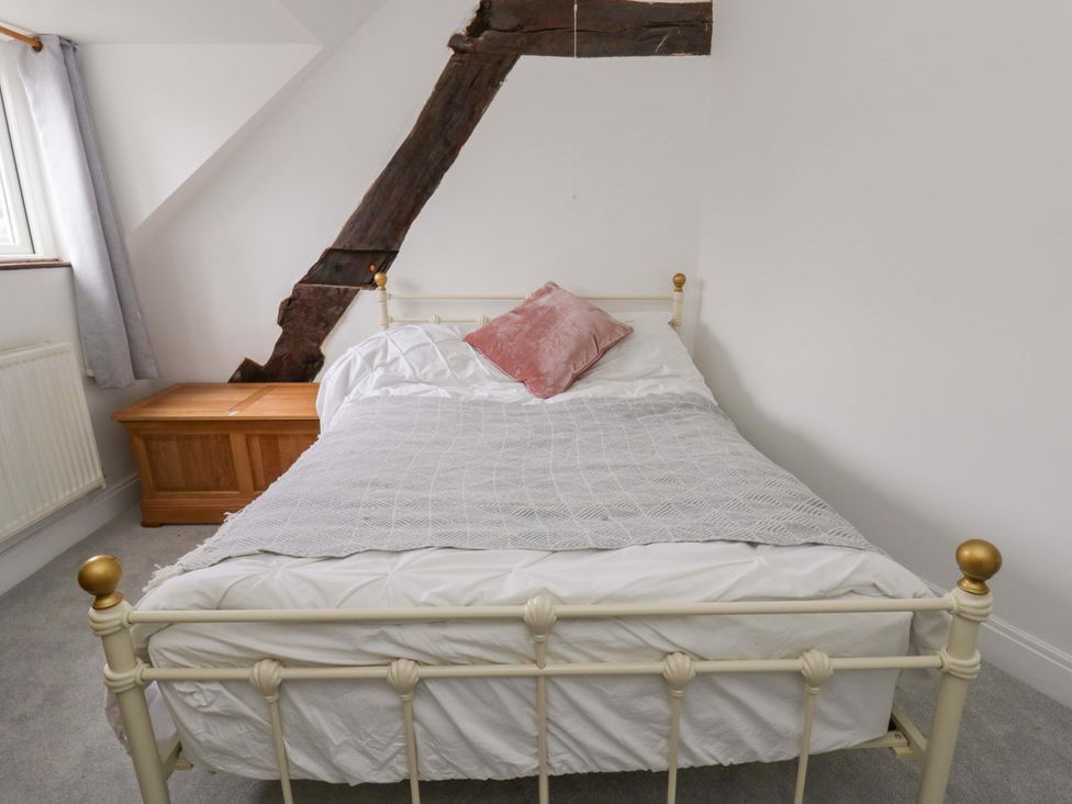 A bedroom with a bed and wooden chest at The Old Shop in Builth Wells