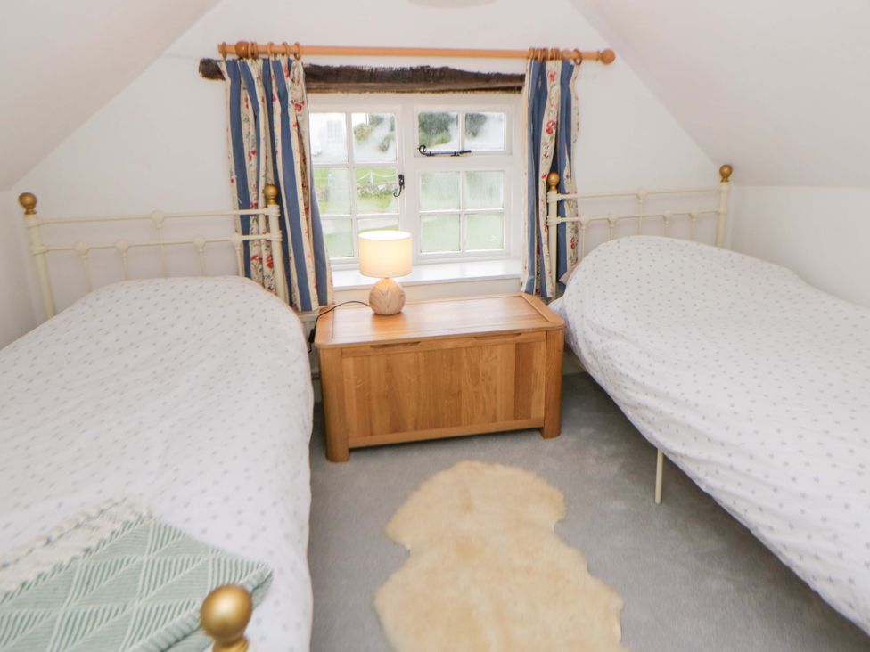 A bedroom with two beds and a window at The Old Shop in Builth Wells