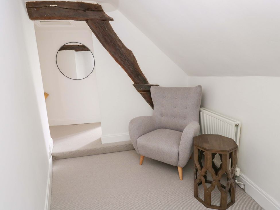 A sitting area with an armchair and a side table at The Old Shop in Builth Wells