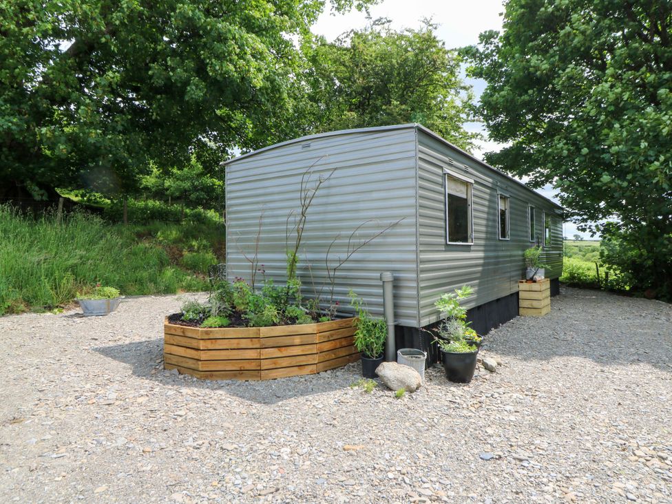A trailer with planters outside at Gwybedog in Llanwrda