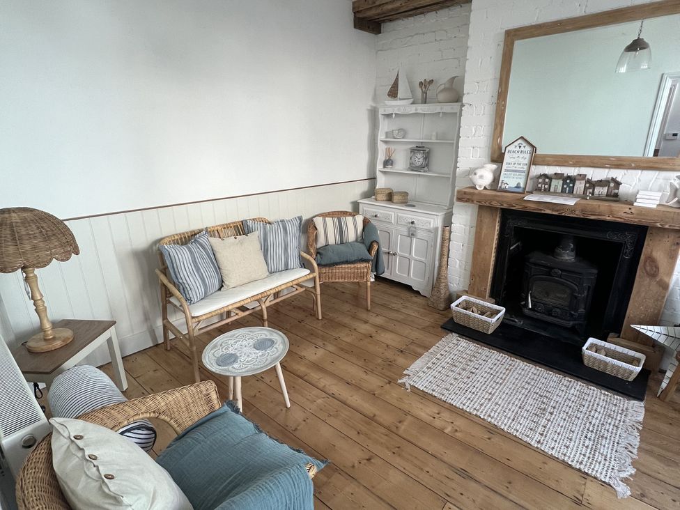 A living room with a sofa and fireplace at 21 Station Hill