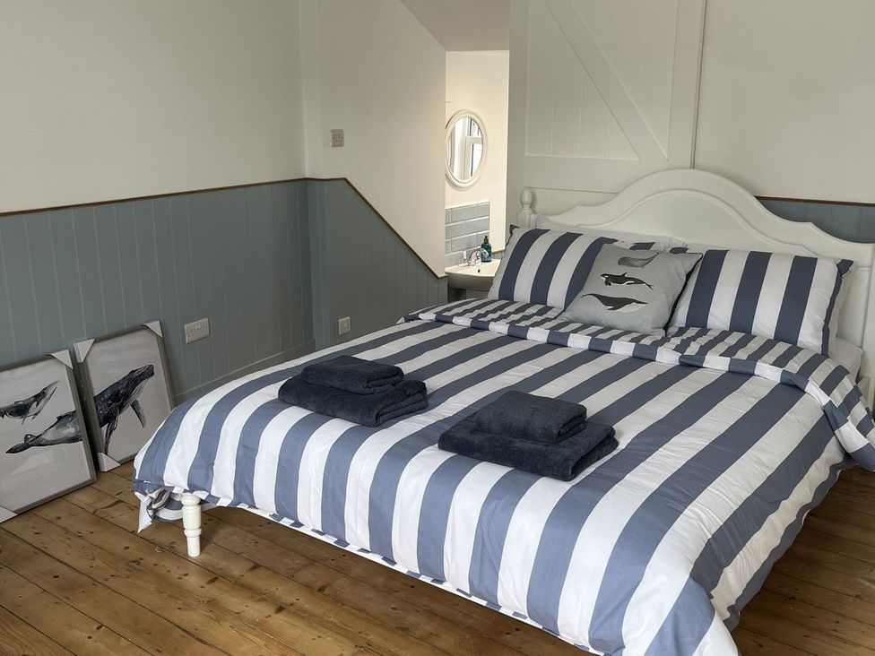 A bedroom with a bed and wall art at 21 Station Hill