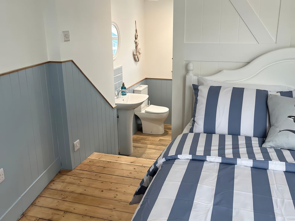 A bedroom with a bed and a bathroom view at 21 Station Hill