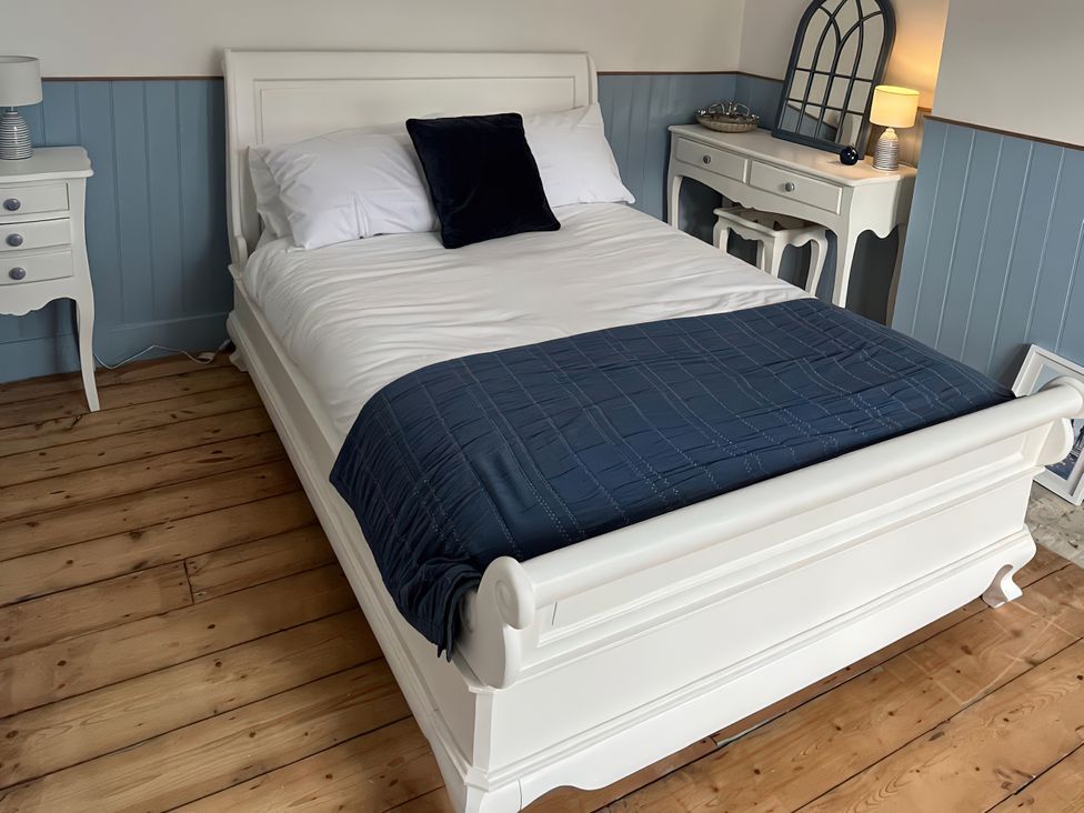 A bedroom with a bed and bedside table at 21 Station Hill