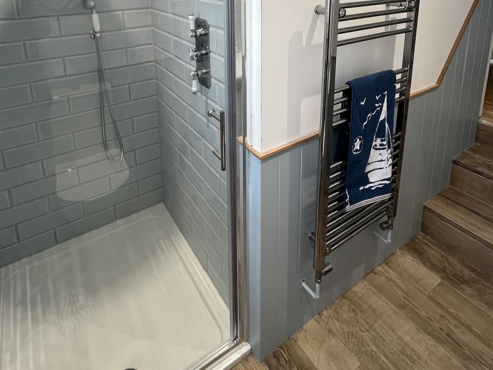 A bathroom with a shower and towel rail at 21 Station Hill