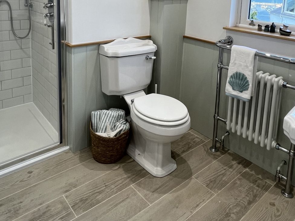 A bathroom with a toilet and shower at 21 Station Hill