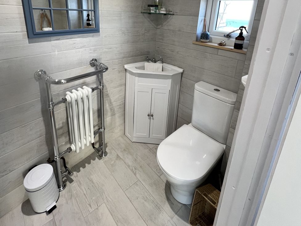 A bathroom with a sink and toilet at Still Waters in Brixham
