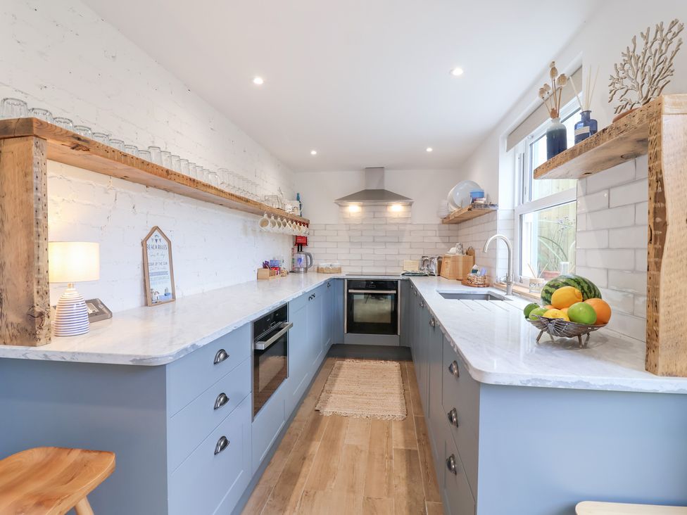 A kitchen with a countertop, sink, and oven at Still Waters in Brixham