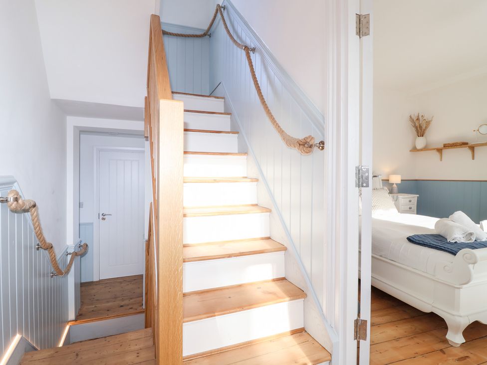 A staircase leading to a bedroom at Still Waters in Brixham