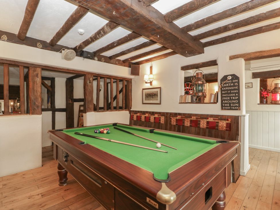 A snug room with a pool table and framed pictures at Penny Farthing Inn Aston Crews near Ross-On-Wye