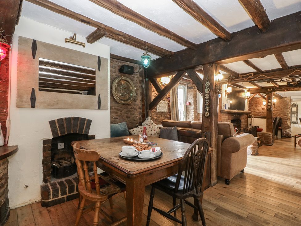 A dining room with a table and chairs at Penny Farthing Inn Aston Crews near Ross-On-Wye