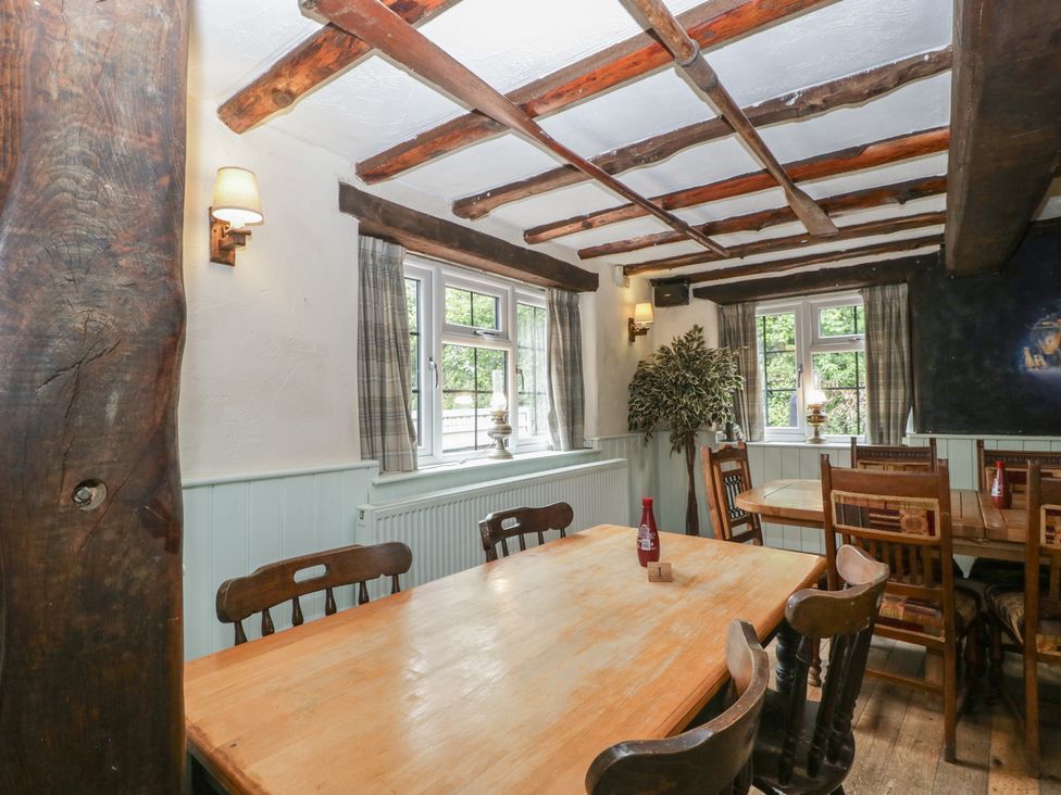 A dining room with a table and chairs at Penny Farthing Inn Aston Crews near Ross-On-Wye
