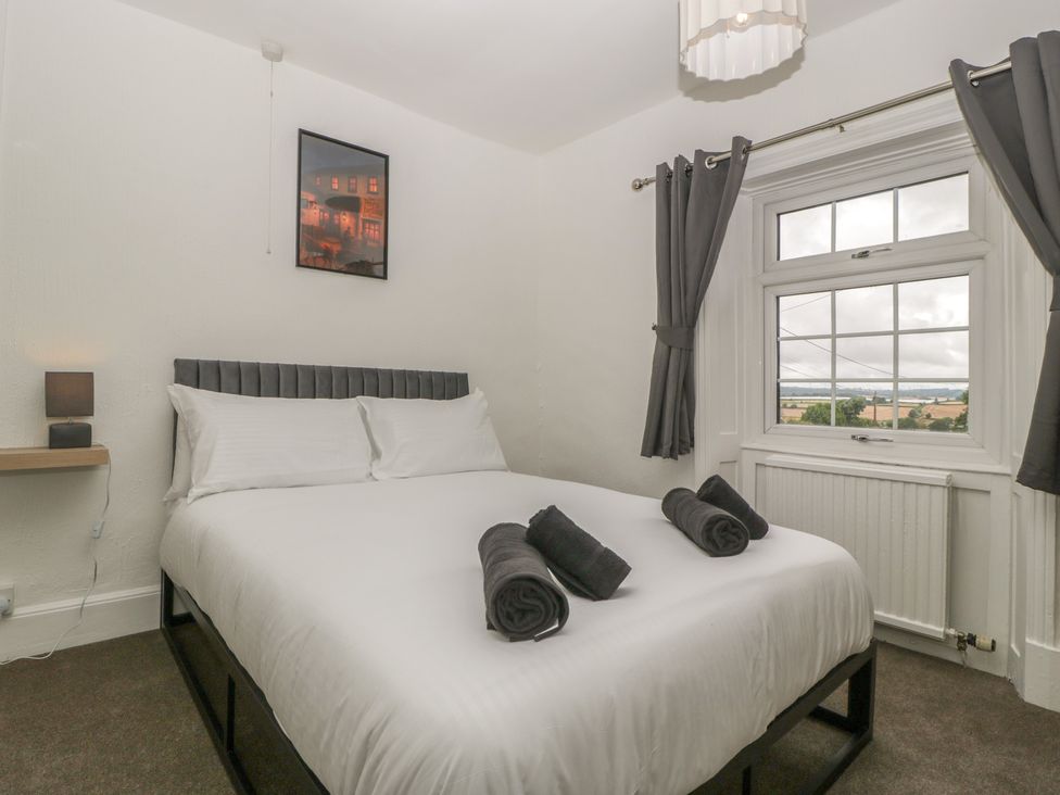 A bedroom with a bed and window at Penny Farthing Inn in Aston Crews near Ross-On-Wye