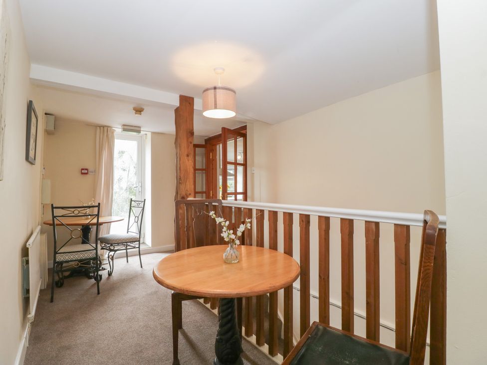 A hallway with a table and chairs at Penny Farthing Inn Aston Crews near Ross-On-Wye