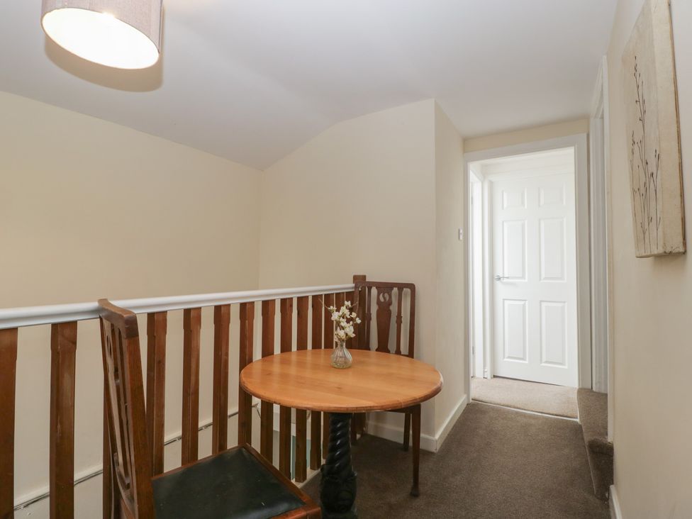 A hallway with a table and chair at Penny Farthing Inn, Aston Crews near Ross-On-Wye