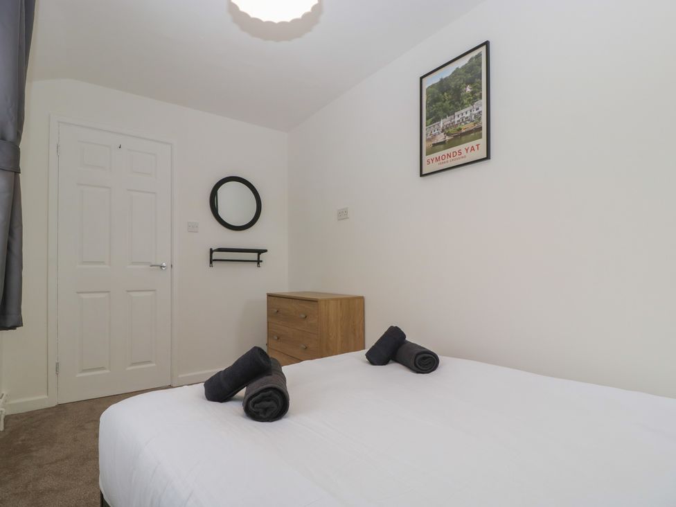 A bedroom with a bed, dresser, and mirror at Penny Farthing Inn Aston Crews near Ross-On-Wye