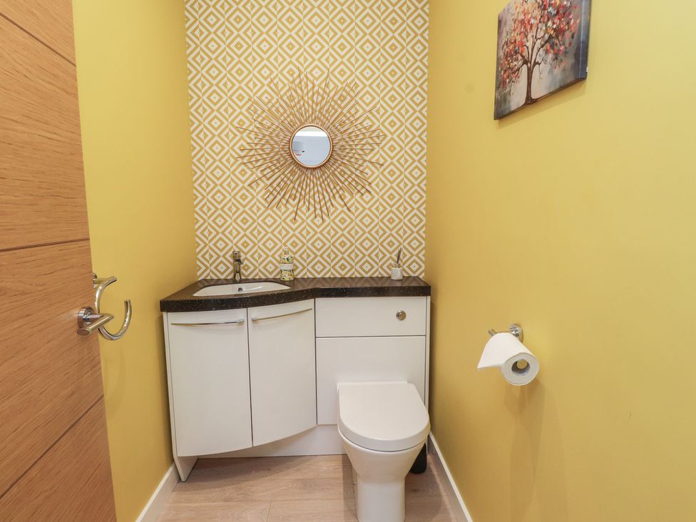 A bathroom with a toilet and sink at 70 Deganwy Road in Deganwy