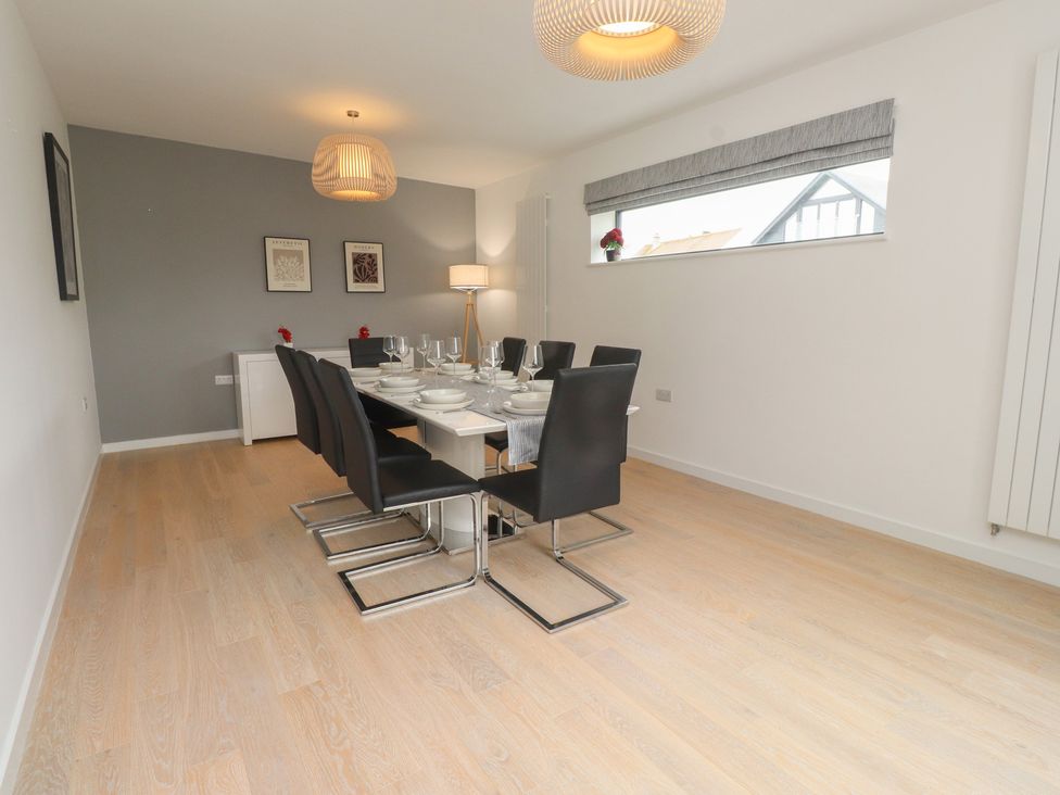 A dining room with a table set for dinner at 70 Deganwy Road in Deganwy