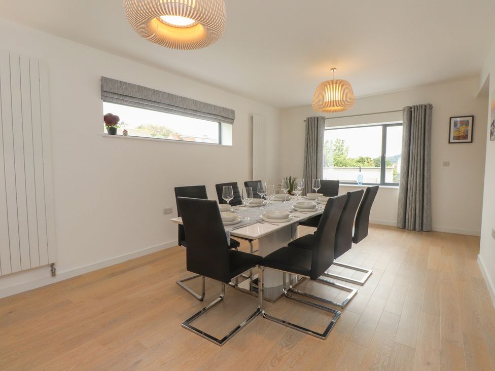 A dining room with a table set for dinner at 70 Deganwy Road in Deganwy