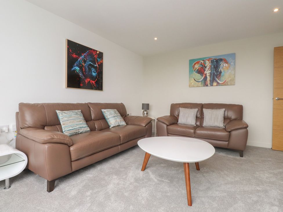 A living room with two sofas and a coffee table at 70 Deganwy Road in Deganwy