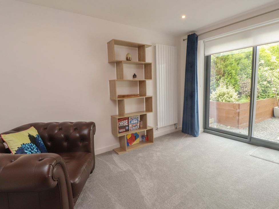 A living room with a sofa and shelf at 70 Deganwy Road in Deganwy