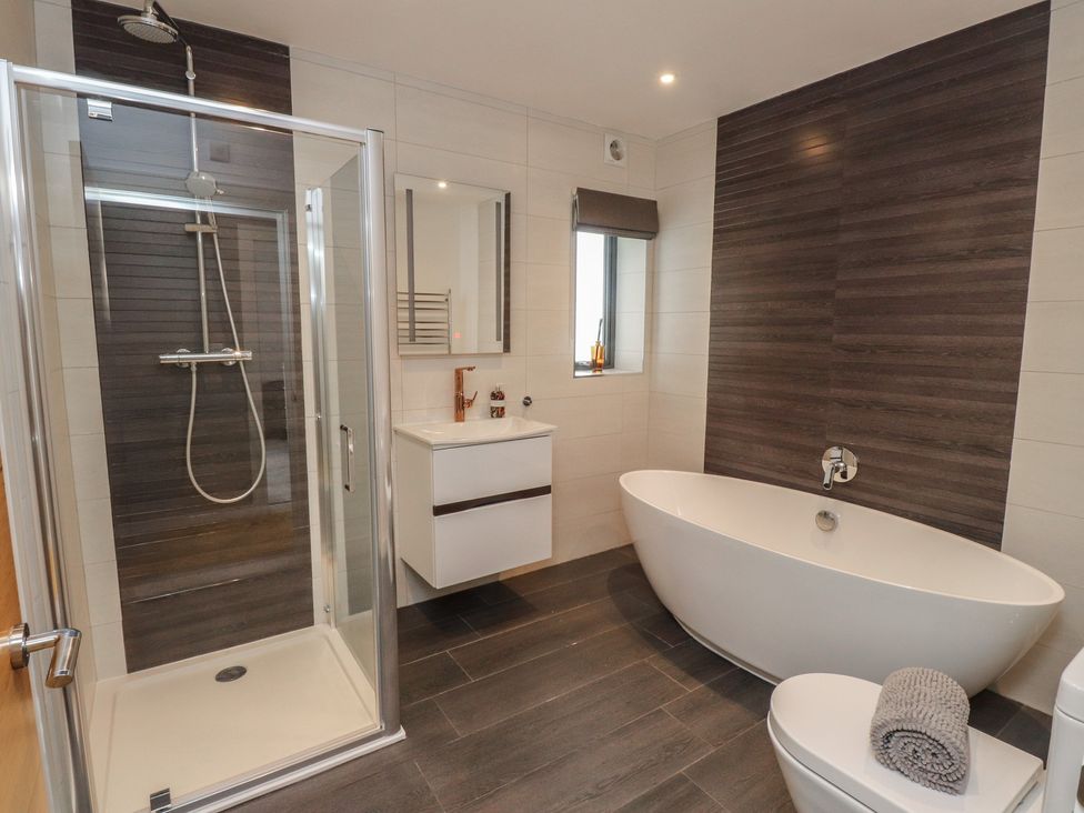 A bathroom with a shower and bathtub at 70 Deganwy Road in Deganwy
