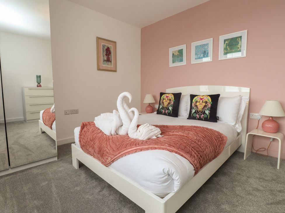 A bedroom with a bed and decor at 70 Deganwy Road in Deganwy