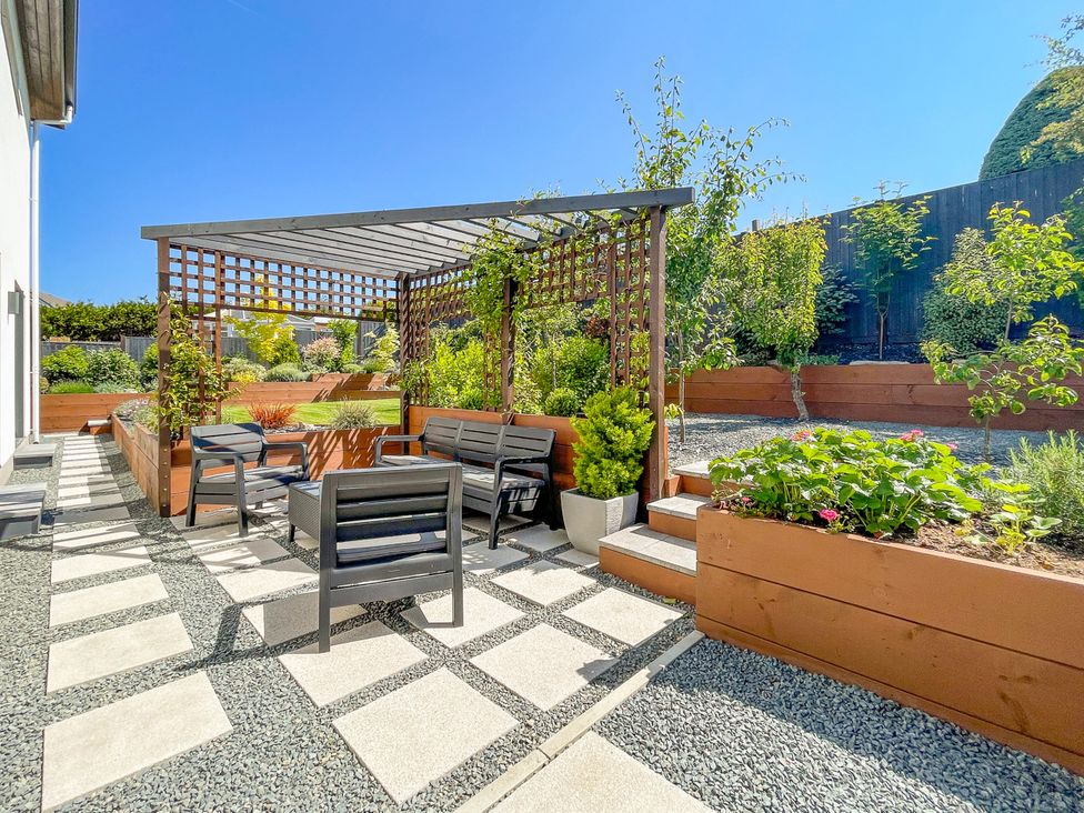 A garden with a seating area and planters at 70 Deganwy Road in Deganwy