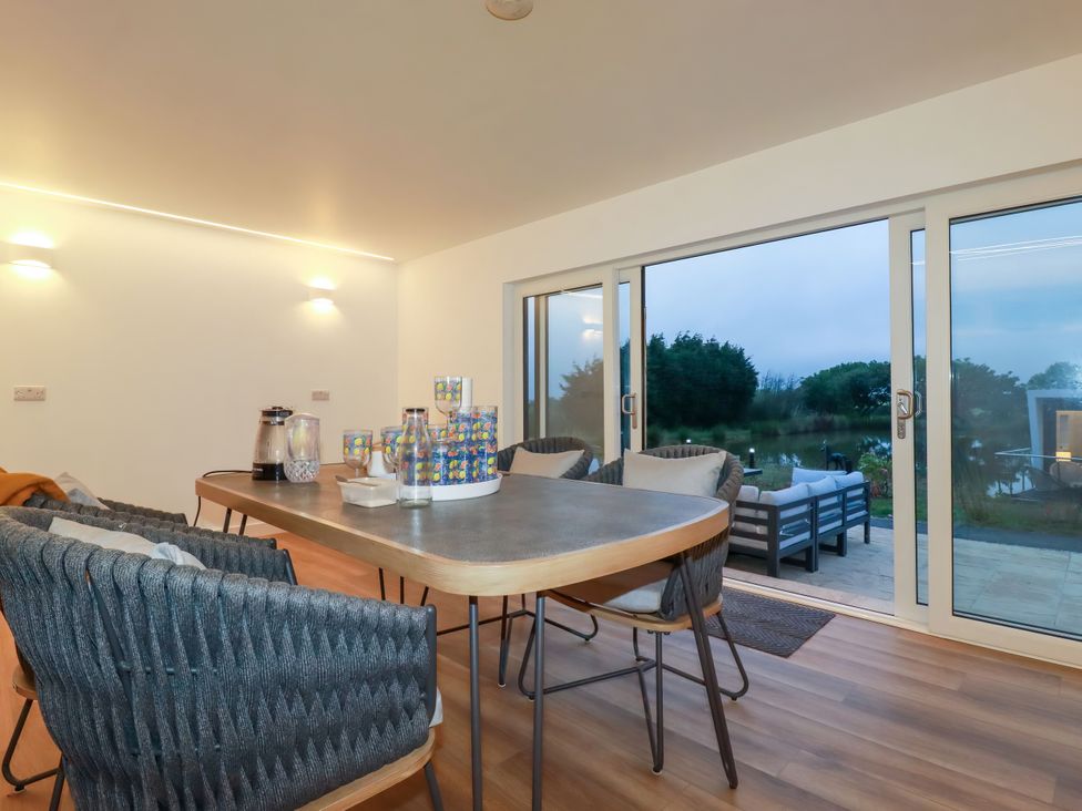 A dining room with a table and chairs at The Lake Boat exclusive retreat Black Cross near St Columb Major