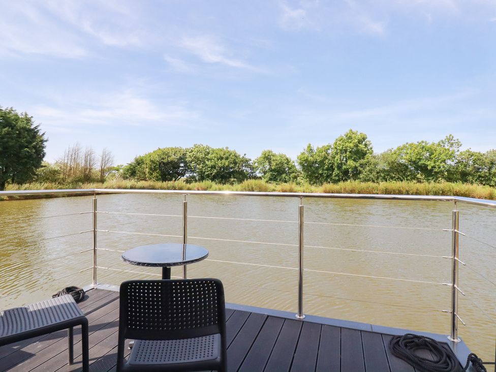 A balcony overlooking water at The Lake Boat exclusive retreat Black Cross near St Columb Major