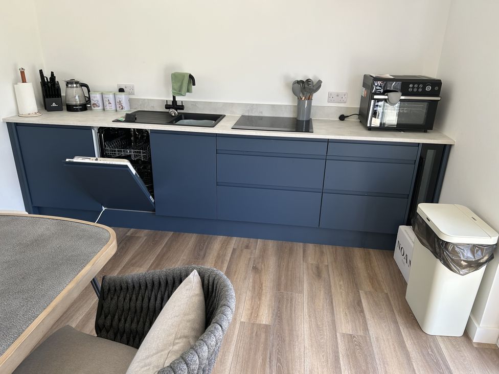 A kitchen with a sink and dishwasher at The Lake Boat exclusive retreat Black Cross near St Columb Major