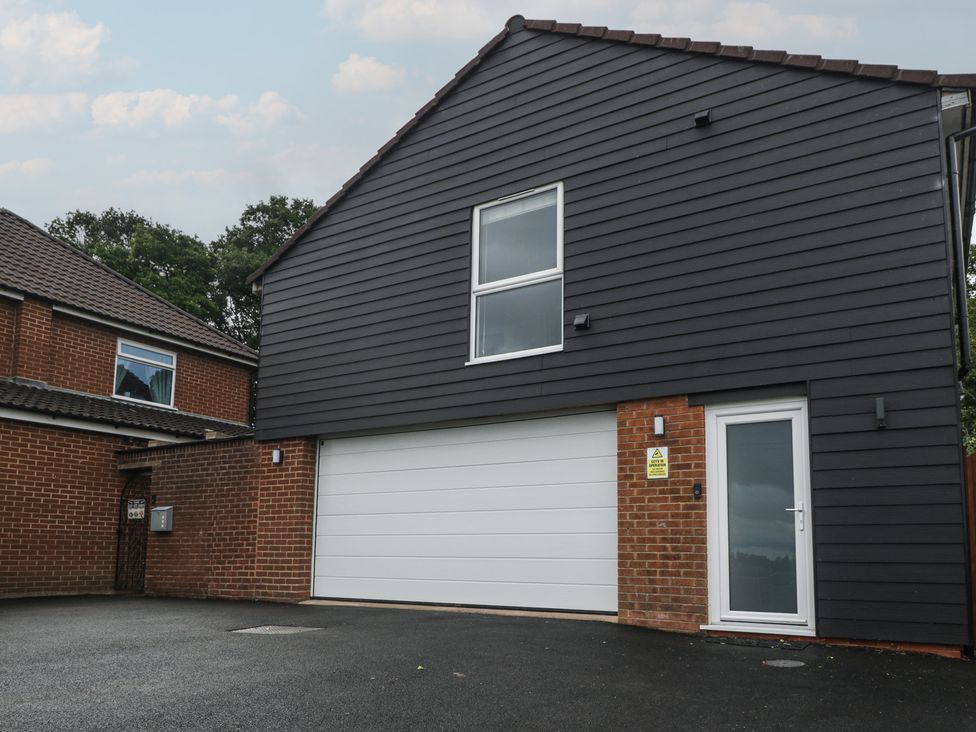 An exterior view of a garage with a white door at The Annex in 