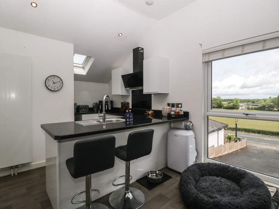 A kitchen with a counter and stools at The Annex in 
