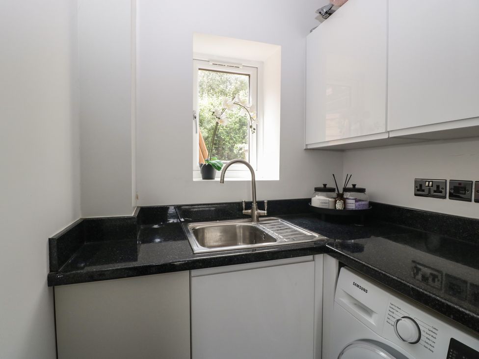 A kitchen with a sink and washing machine at The Annex