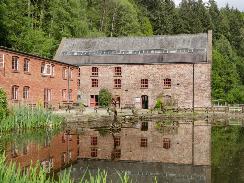 A building with a reflection in the water at The Annex 