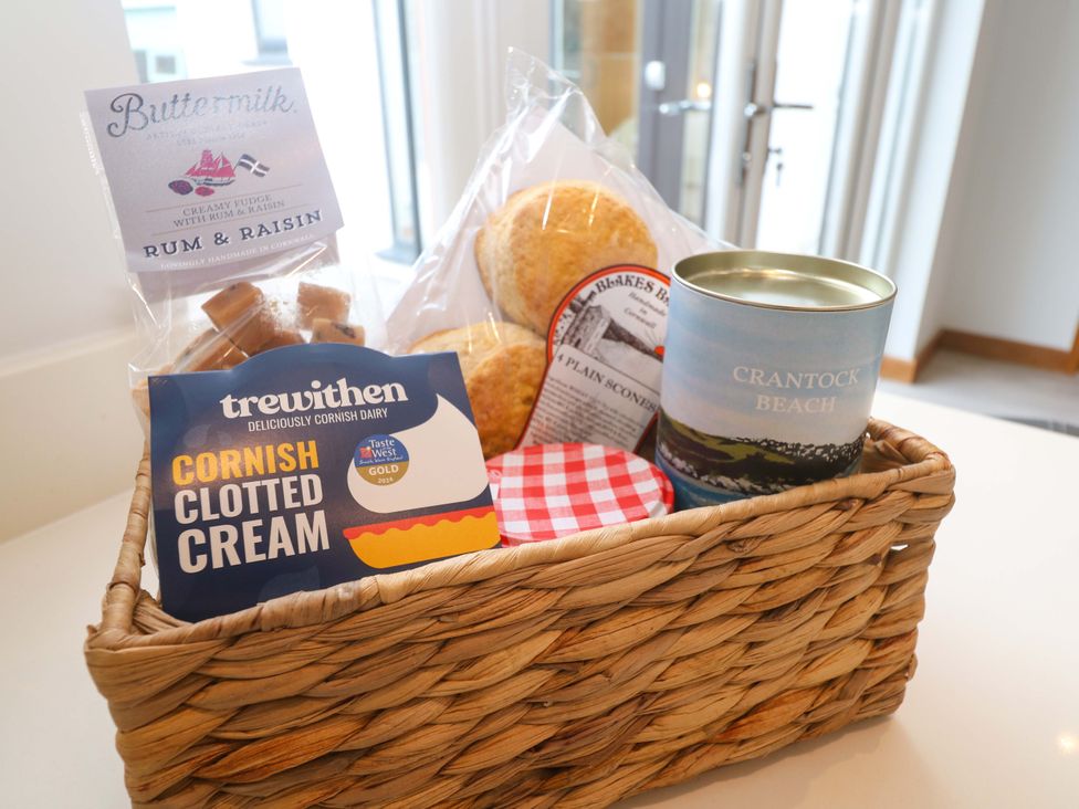 A basket with various food items including fudge and clotted cream at Byron’s Retreat Crantock