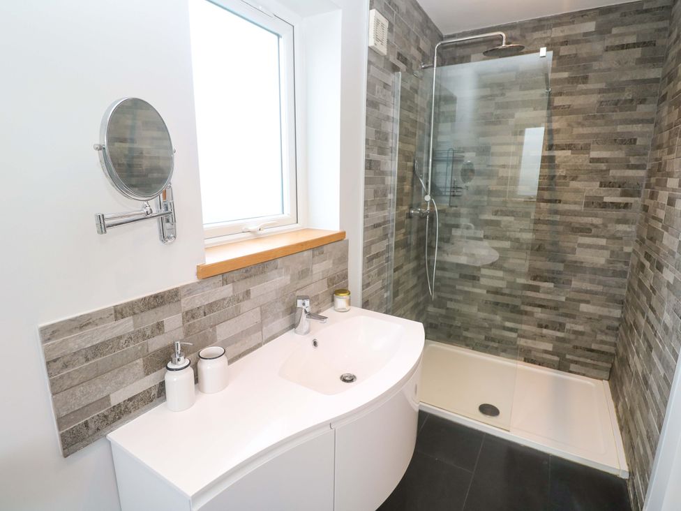 A bathroom with a shower and sink at Byron’s Retreat in Crantock
