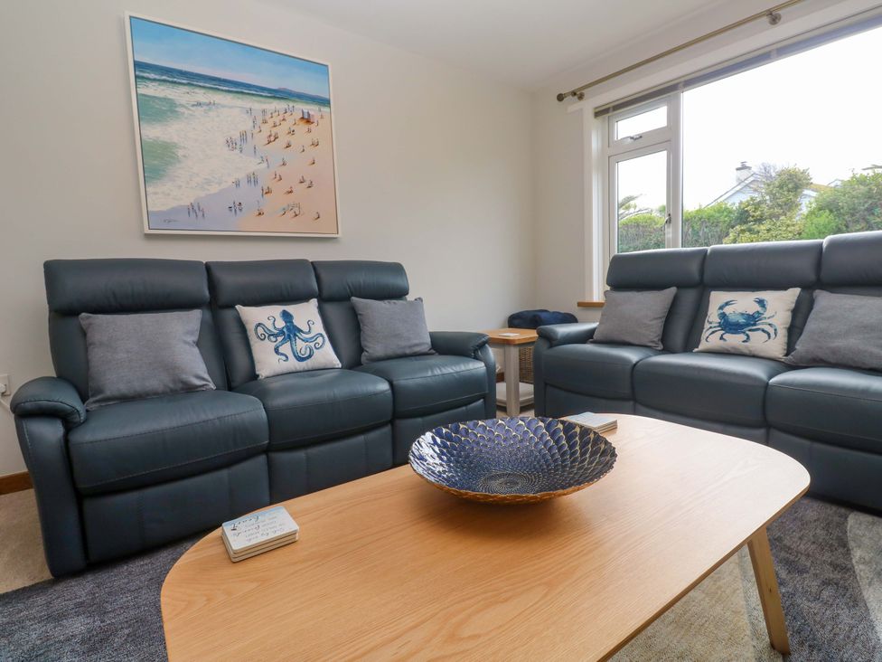 A living room with two sofas and a table at Byron’s Retreat in Crantock