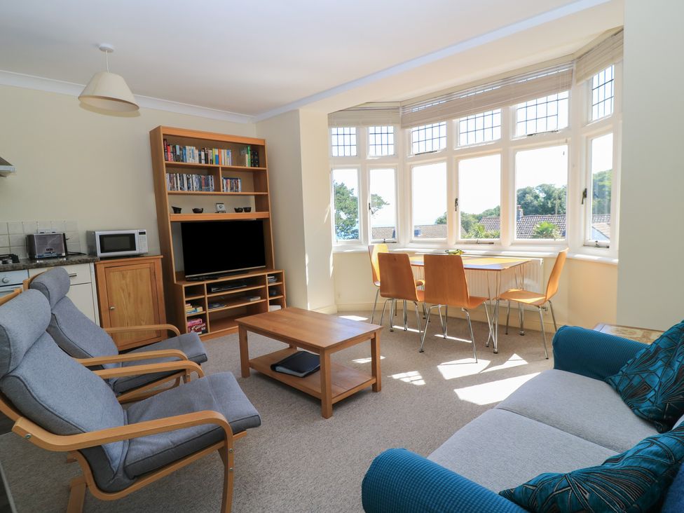 A living room with a sofa coffee table and television at Purbeck Vista in Swanage