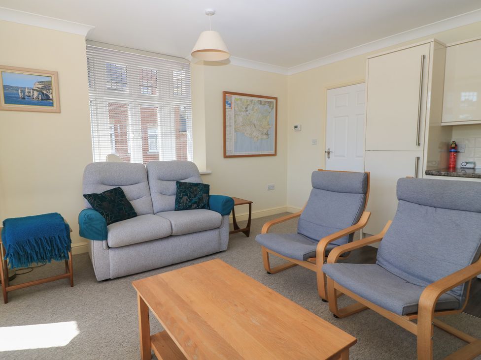A living room with a sofa and two armchairs at Purbeck Vista in Swanage