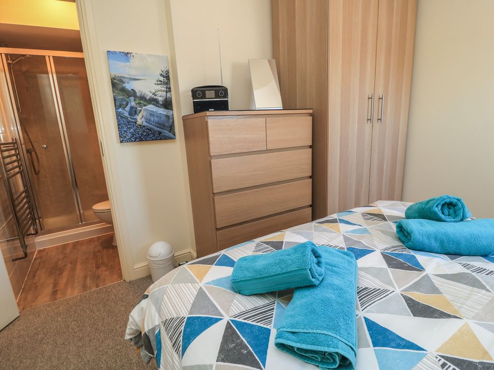 A bedroom with a bed and towels arranged at Purbeck Vista in Swanage