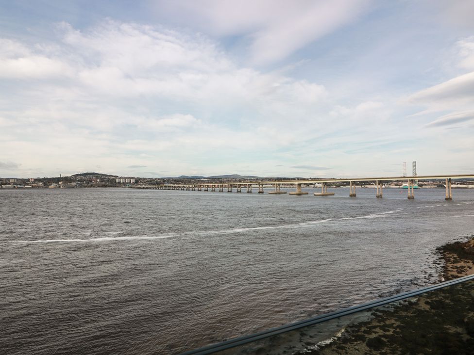A bridge spanning water with a city in the background at Lazy Bulldog
