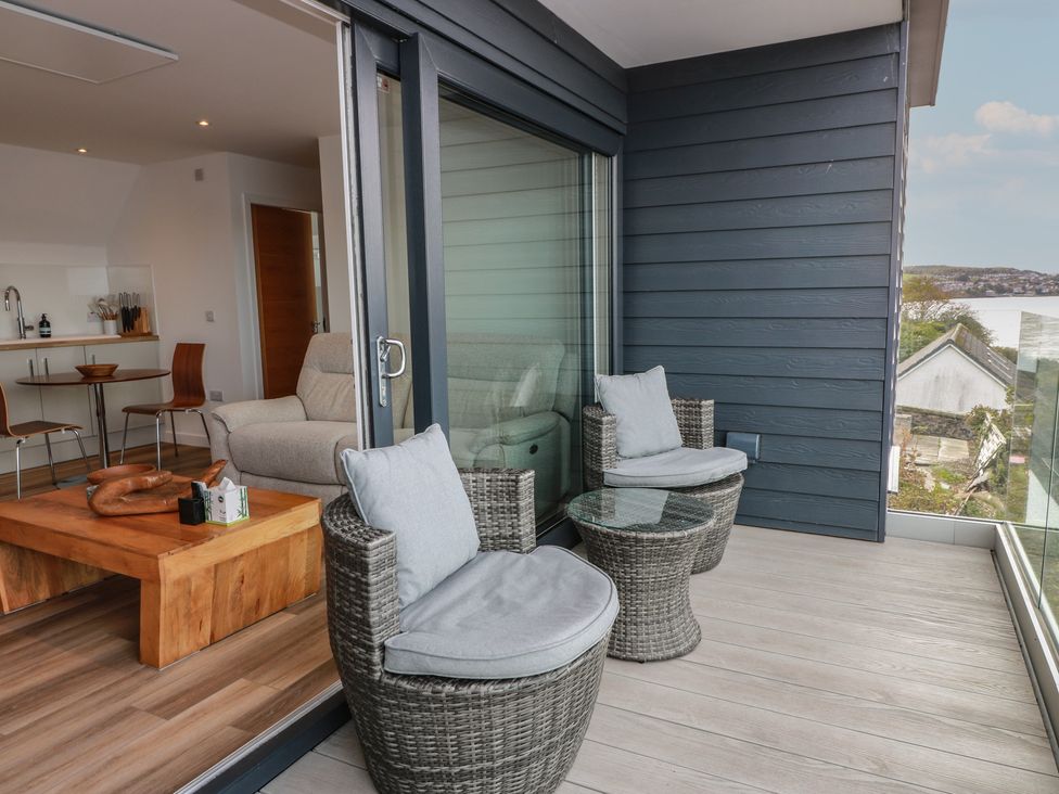 A balcony with two chairs and a table at Lazy Bulldog 