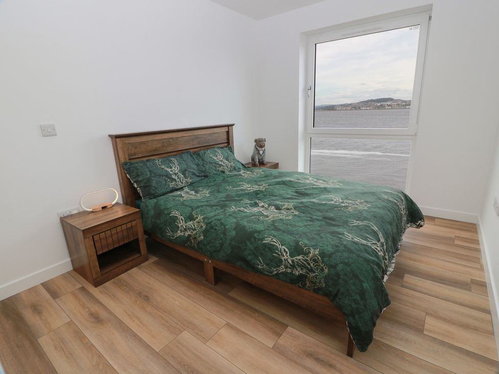 A bedroom with a bed and nightstand at Lazy Bulldog